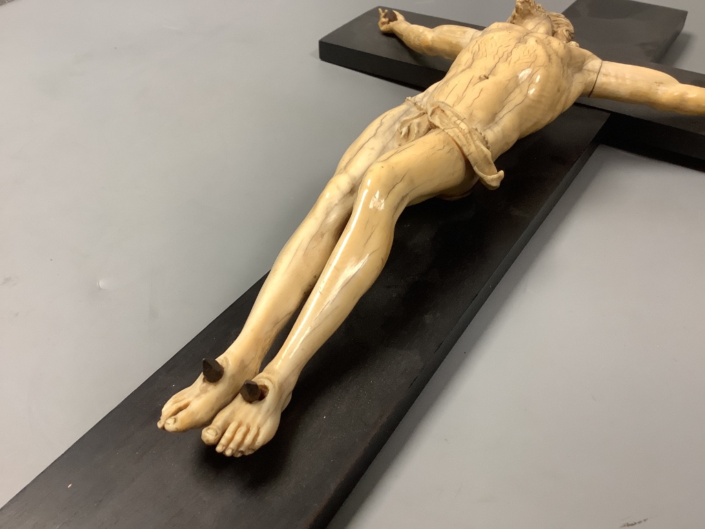 A 19th century Dieppe carved ivory and ebony crucifix, overall length 48cm